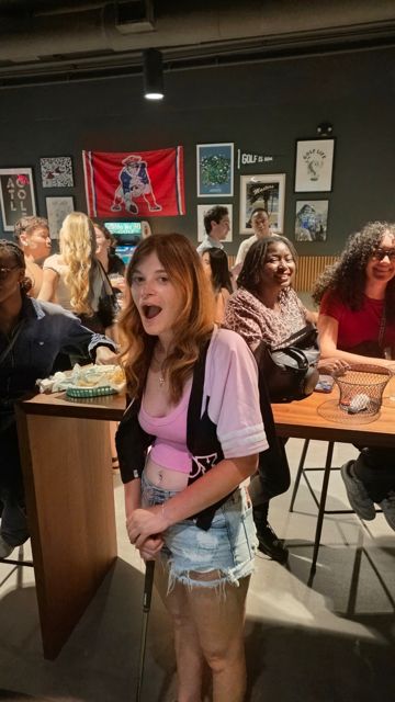 Guests smiling at a crowded bar table