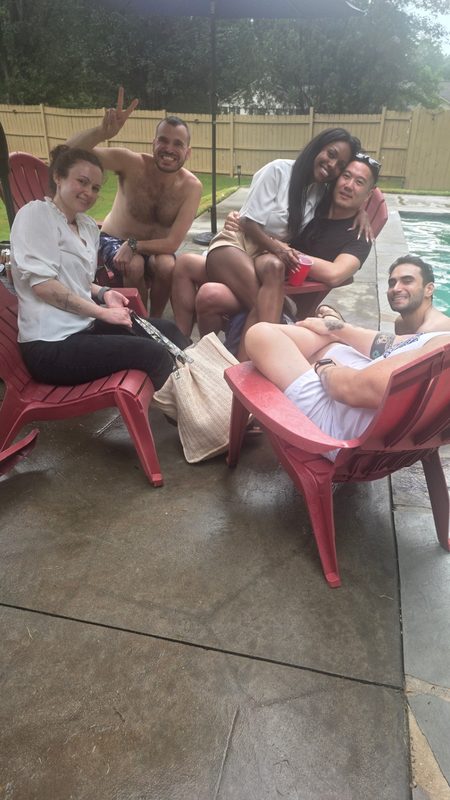Six friends relaxing on poolside chairs in a backyard