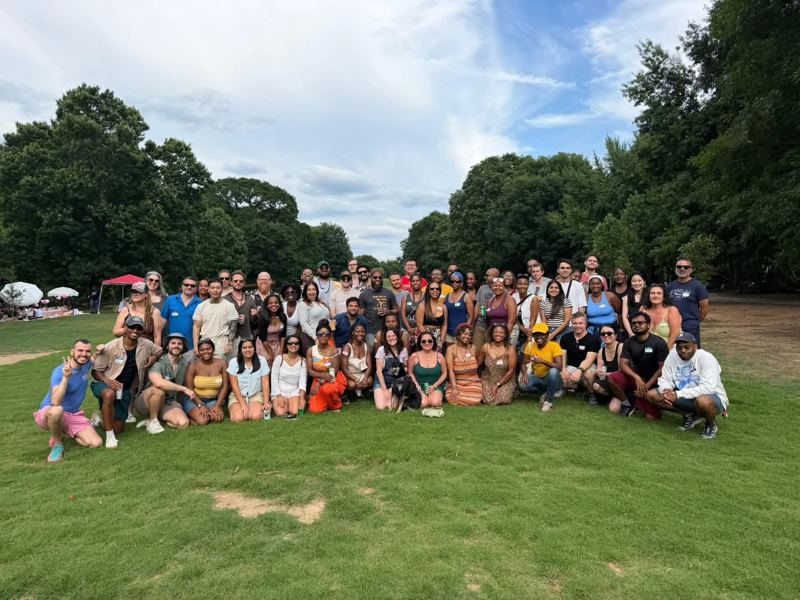 A large group photo of the club on a sunny lawn