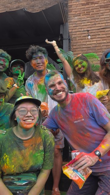 Friends covered in bright color powder at a Holi celebration